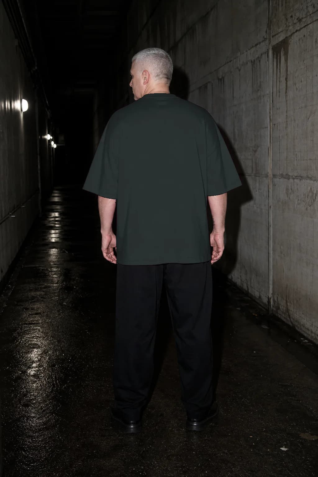 Abyss heavyweight T-shirt, rear three-quarter fit on a silver-haired adult model, personalized with number —